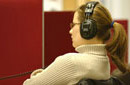 A student listening to a recording